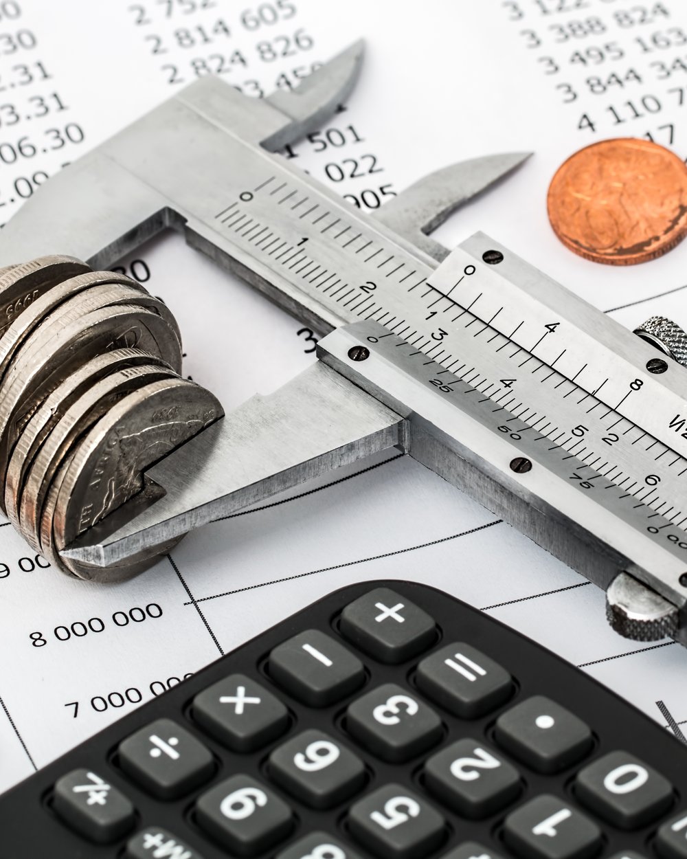 Calculator, coins and a financial statement